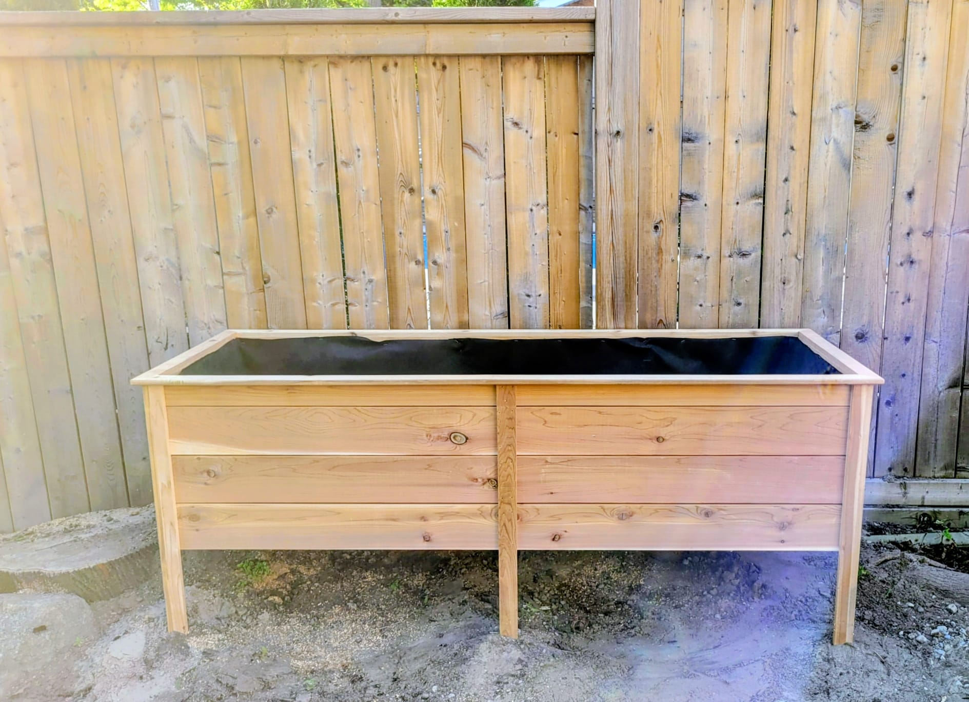 Custom elevated cedar raised garden bed built in a Toronto backyard